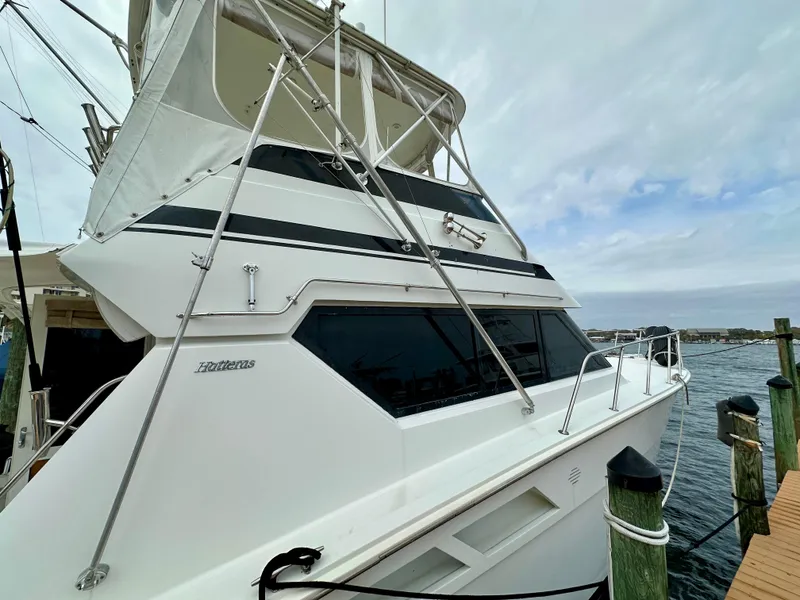 Slide: The Image of 1994 Hatteras 46 Convertible yacht docked by the water. - 6