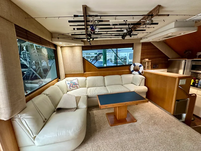 Slide: The Image of Luxurious interior of 1994 Hatteras 46 Convertible yacht with plush seating and fishing rods. - 71