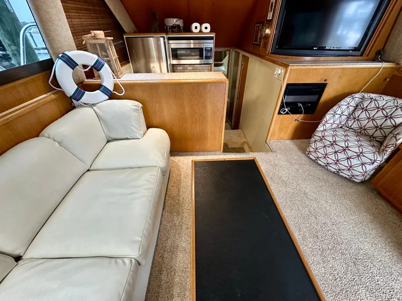 Slide: The Image of Interior of 1994 Hatteras 46 Convertible yacht with sofa, TV, and kitchenette. - 74