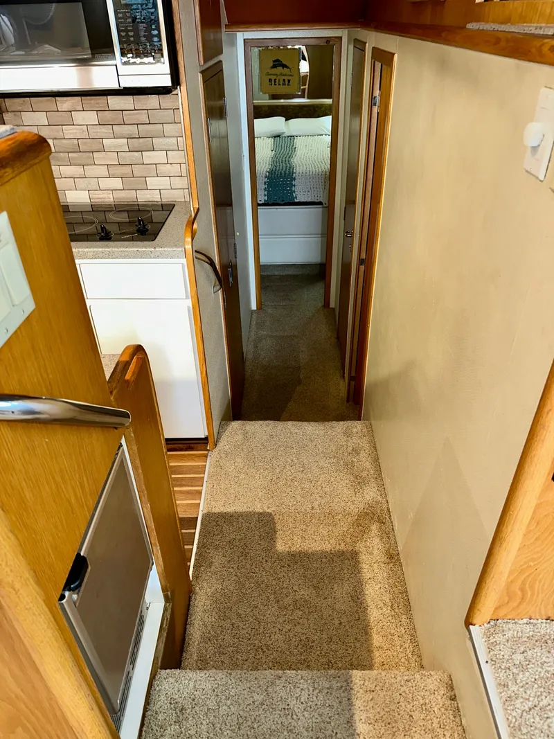 Slide: The Image of Interior view of 1994 Hatteras 46 Convertible yacht, featuring carpeted stairs and cozy cabin. - 82