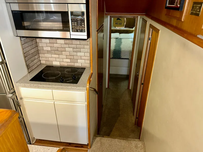 Slide: The Image of Interior of 1994 Hatteras 46 Convertible yacht with modern kitchen and hallway view. - 84