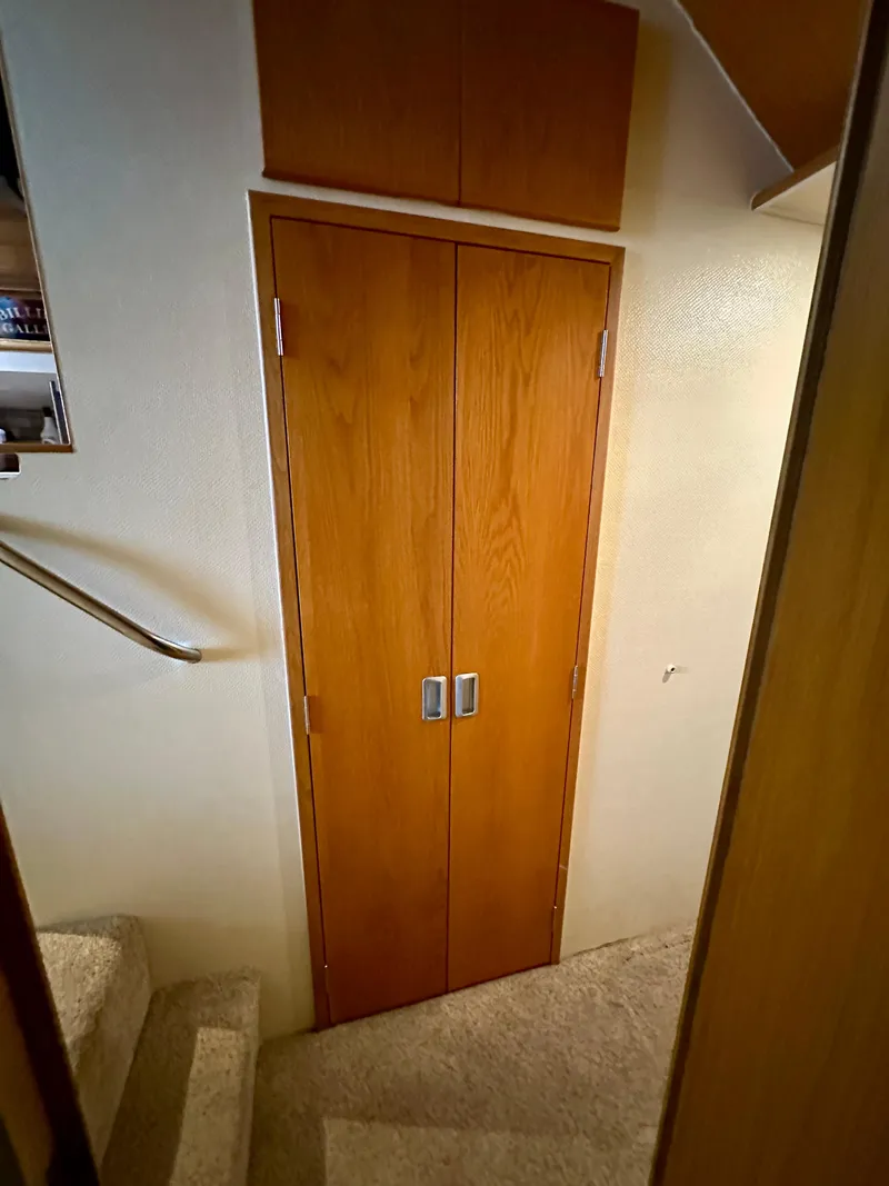 Slide: The Image of Interior of 1994 Hatteras 46 Convertible yacht with wooden doors and carpeted stairs. - 96