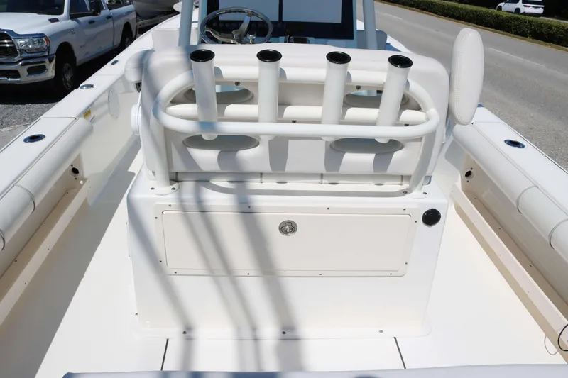 Slide: The Image of 2022 Sea Born FX25 Bay boat interior with rod holders and seating. - 11