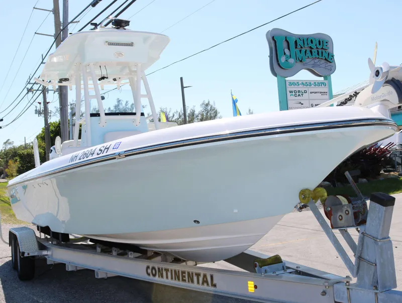 Slide: The Image of 2022 Sea Born FX25 Bay boat on trailer at Unique Marine dealership. - 2