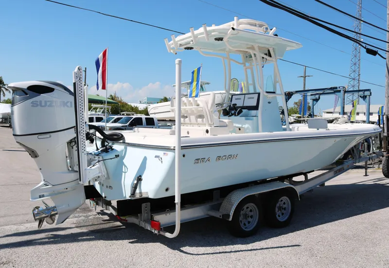 Slide: The Image of 2022 Sea Born FX25 Bay boat on trailer, featuring Suzuki outboard motor. - 3