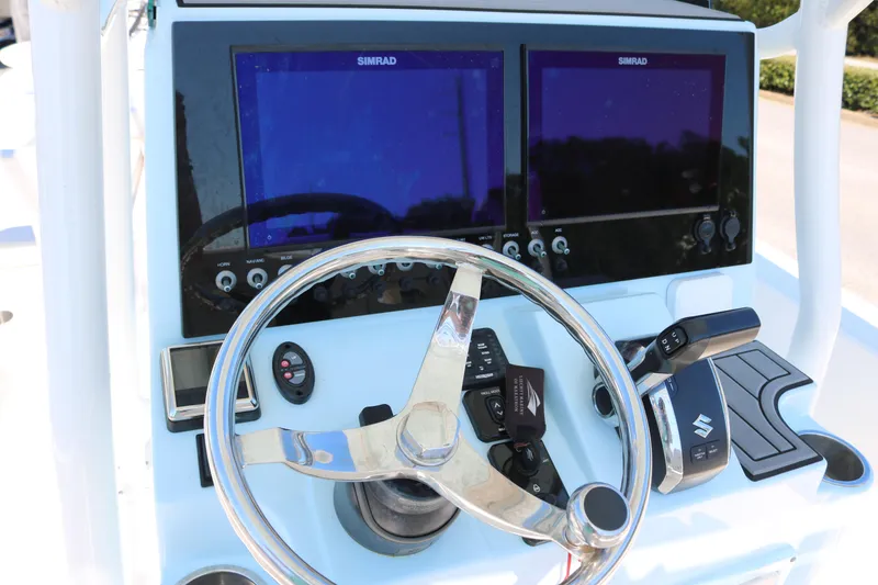 Slide: The Image of Control panel of 2022 Sea Born FX25 Bay boat with dual Simrad displays. - 6