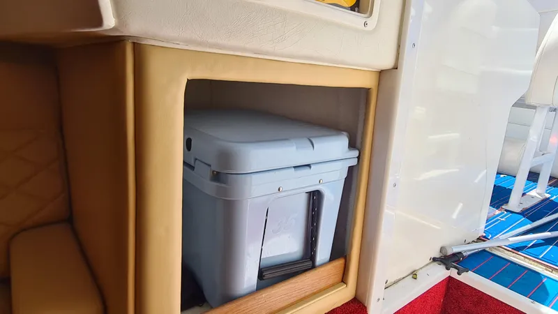 Slide: The Image of Interior of a 2000 Cigarette Tiger 42 boat with a storage compartment. - 14