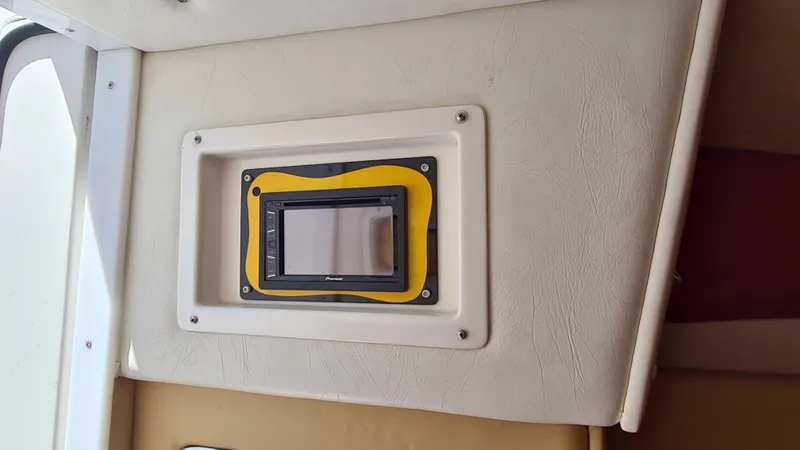 Slide: The Image of Control panel inside a 2000 Cigarette Tiger 42 boat, featuring a yellow frame. - 15