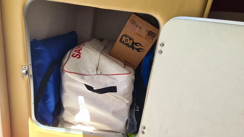 Slide: The Image of Storage compartment on a 2000 Cigarette Tiger 42 boat with bags and a box. - 16