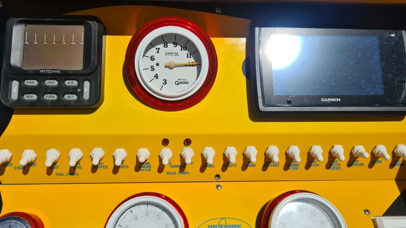 Slide: The Image of Control panel of a 2000 Cigarette Tiger 42 boat with gauges and switches. - 23