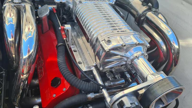 Slide: The Image of Engine of a 2000 Cigarette Tiger 42 boat, featuring chrome and red components. - 28