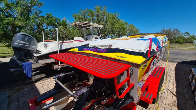 Slide: The Image of Cigarette Tiger 42 speedboat, 2000 model, vibrant colors, parked outdoors on a sunny day. - 3