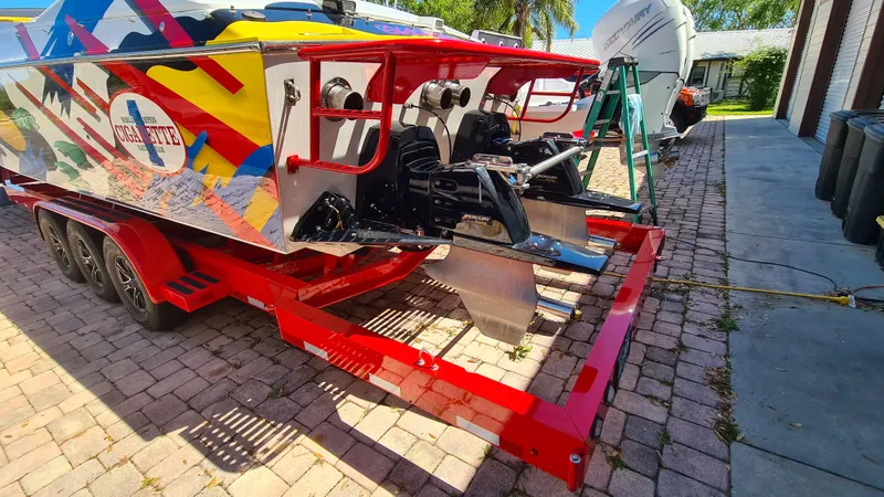 Slide: The Image of Cigarette Tiger 42 boat, 2000 model, vibrant design, parked on a brick driveway. - 30