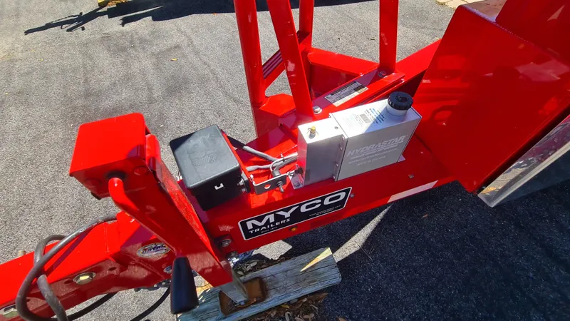 Slide: The Image of Red Myco trailer hitch for Cigarette Tiger 42, 2000 model, on asphalt surface. - 31