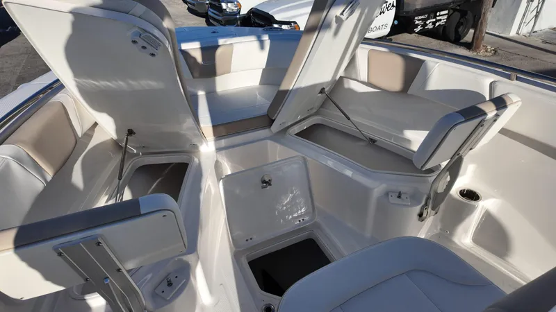 Slide: The Image of 2025 Robalo R230 boat interior with open storage compartments and seating. - 11