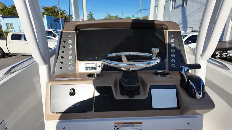 Slide: The Image of 2025 Robalo R230 boat dashboard with steering wheel and control panel. - 6