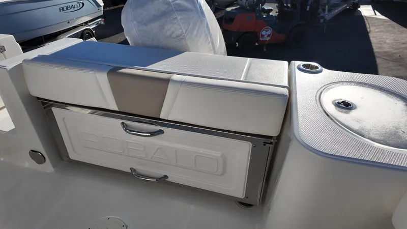 Slide: The Image of 2025 Robalo R230 boat interior with cushioned seating and storage compartment. - 7