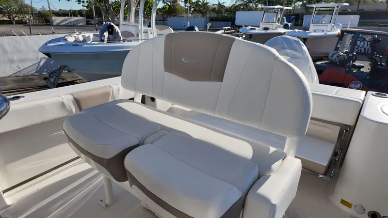 Slide: The Image of 2025 Robalo R230 boat interior with cushioned seating and sleek design. - 9