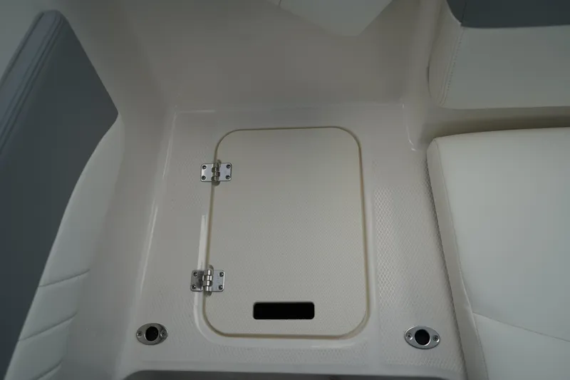 Slide: The Image of 2025 Chaparral 21 SSi OB boat with open storage compartment, showcasing interior design. - 11