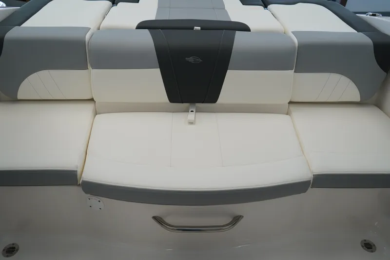 Slide: The Image of 2025 Chaparral 21 SSi OB boat storage compartment with hinged lid and textured surface. - 16