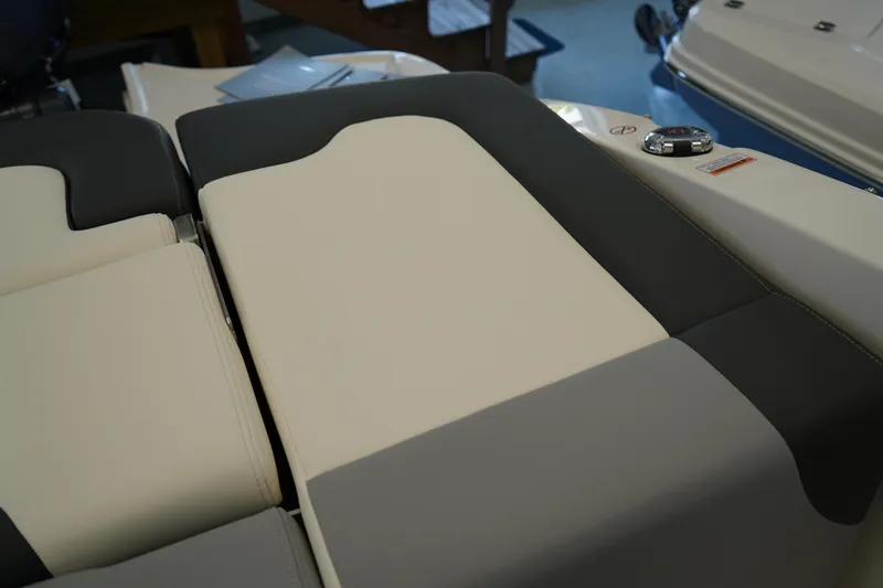 Slide: The Image of 2025 Chaparral 21 SSi OB boat interior with white seating and storage compartment. - 18