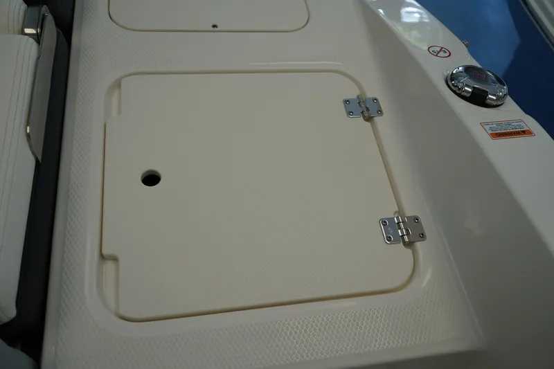 Slide: The Image of 2025 Chaparral 21 SSi OB boat storage compartment with wrapped item inside. - 19