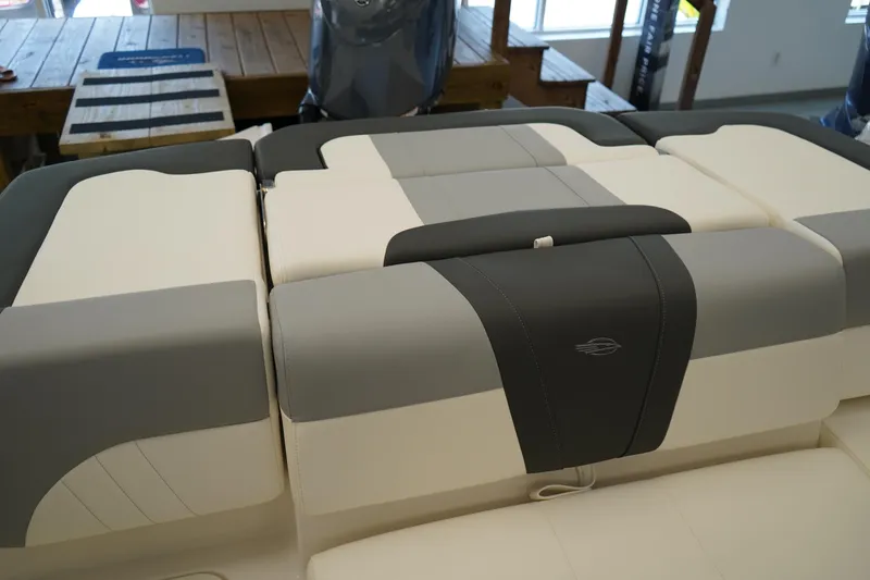 Slide: The Image of 2025 Chaparral 21 SSi OB boat interior with gray and white cushioned seating. - 2