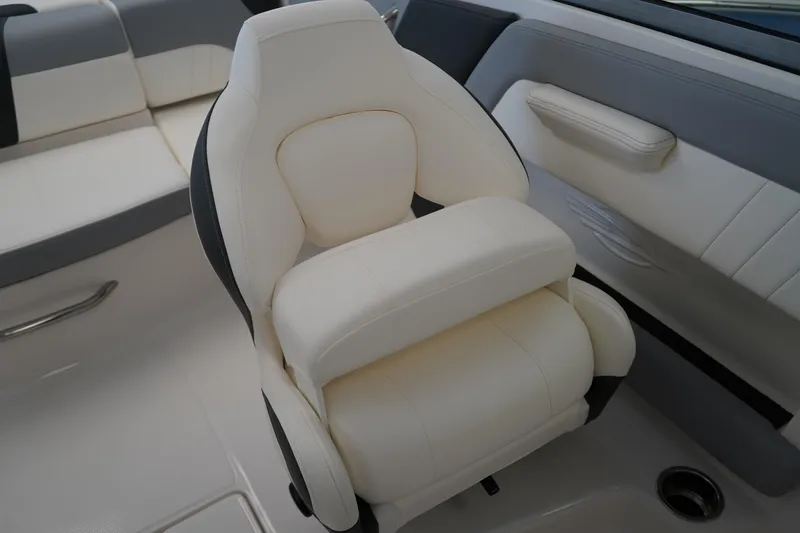 Slide: The Image of 2025 Chaparral 21 SSi OB boat dashboard with storage compartment and cup holder. - 23