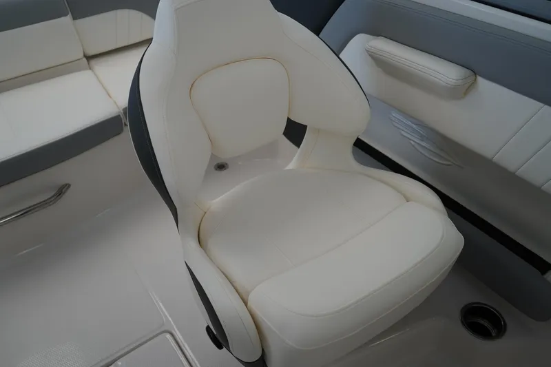 Slide: The Image of 2025 Chaparral 21 SSi OB boat interior with white cushioned seating. - 24