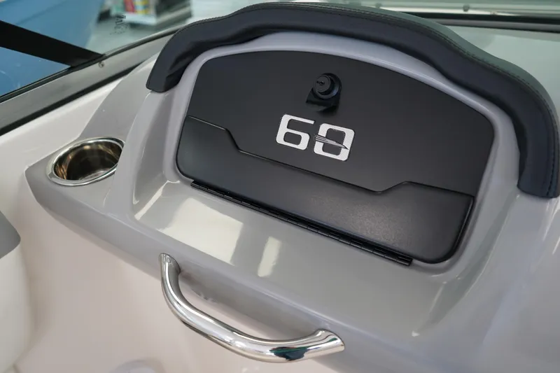 Slide: The Image of 2025 Chaparral 21 SSi OB boat interior with white cushioned seating and steering wheel. - 25