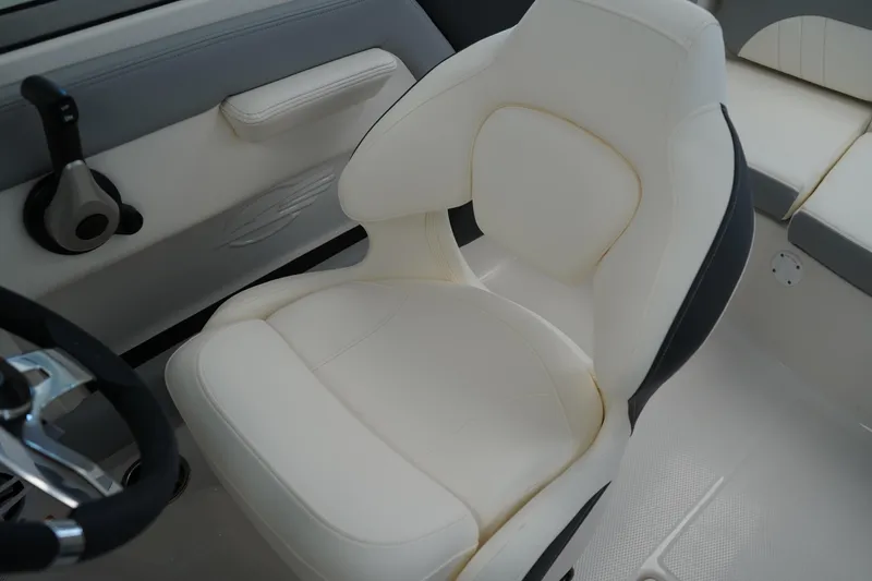 Slide: The Image of Control panel of 2025 Chaparral 21 SSi OB boat with steering wheel and switches. - 28