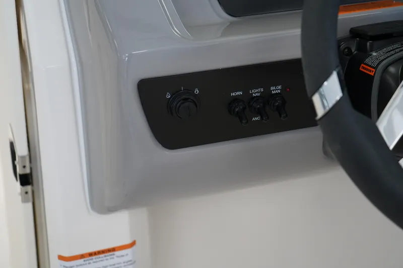 Slide: The Image of 2025 Chaparral 21 SSi OB boat interior storage compartment with netted pocket. - 31