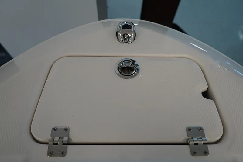 Slide: The Image of 2025 Chaparral 21 SSi OB boat displayed indoors, featuring sleek design and modern amenities. - 40