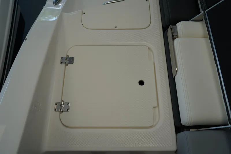Slide: The Image of Storage compartment in 2025 Chaparral 21 SSi OB boat, open lid view. - 9