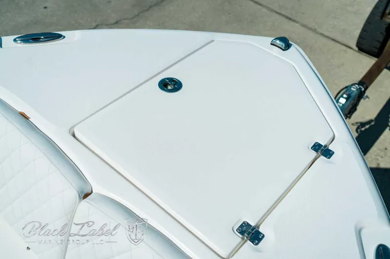 Slide: The Image of 2025 Sea Fox 268 Commander boat deck with storage compartment and sleek design. - 14