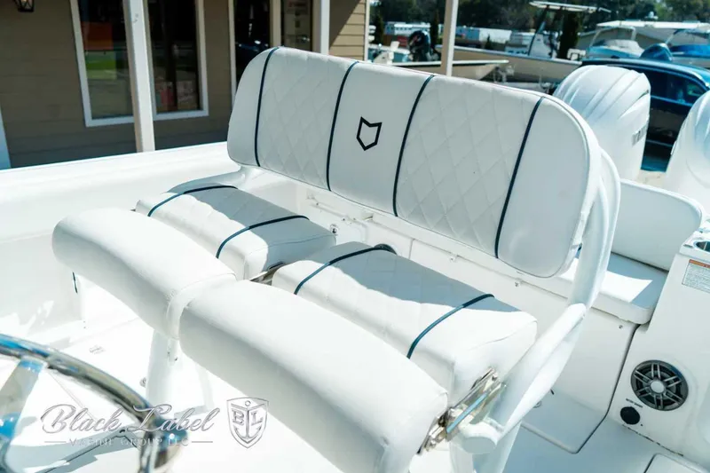 Slide: The Image of 2025 Sea Fox 268 Commander boat seating with white upholstery and diamond stitching. - 22