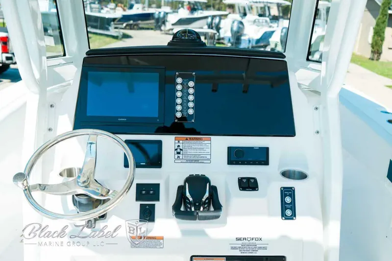 Slide: The Image of Helm of 2025 Sea Fox 268 Commander boat with steering wheel and control panel. - 24