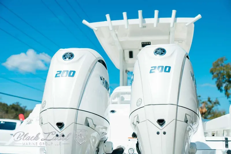 Slide: The Image of Twin Yamaha 200 engines on a 2025 Sea Fox 268 Commander boat under clear blue sky. - 5