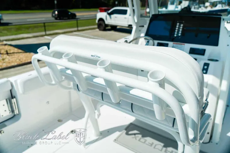 Slide: The Image of 2025 Sea Fox 268 Commander boat interior with rod holders and control panel. - 8