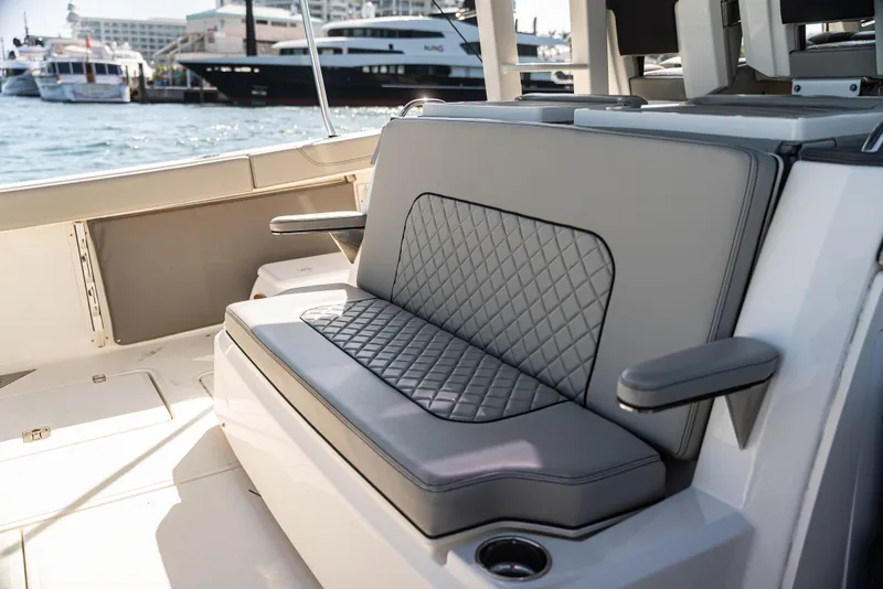 Slide: The Image of Luxury seating on a 2021 Pursuit 428 boat, featuring diamond-stitched upholstery. - 12