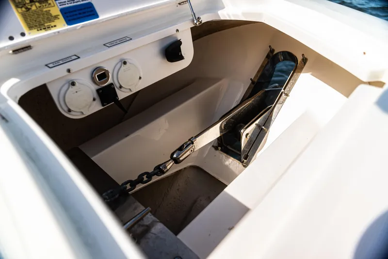 Slide: The Image of Anchor compartment of 2021 Pursuit 428 boat with chain and controls. - 14