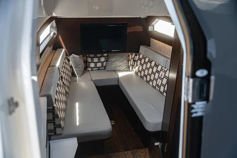 Slide: The Image of Luxurious interior of 2021 Pursuit 428 boat with modern seating and TV. - 15