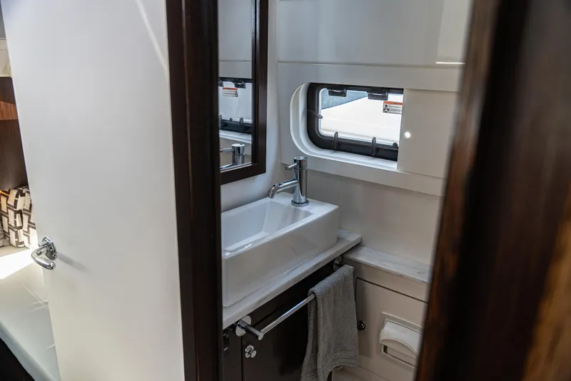 Slide: The Image of Modern bathroom interior in 2021 Pursuit 428, featuring sleek sink and window. - 17