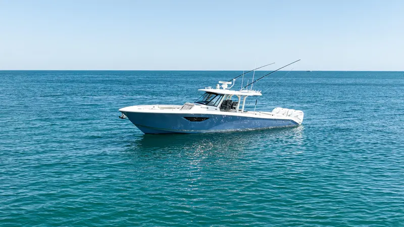 Slide: The Image of 2021 Pursuit 428 boat on calm blue ocean waters. - 2