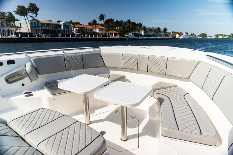 Slide: The Image of Luxurious seating area on a 2021 Pursuit 428 boat with waterfront view. - 5