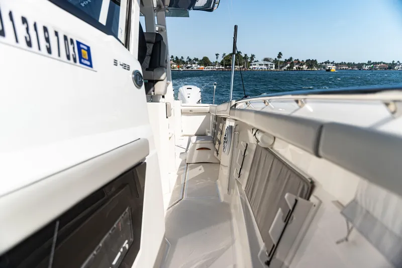 Slide: The Image of 2021 Pursuit 428 boat deck with ocean view, showcasing sleek design and spacious layout. - 6