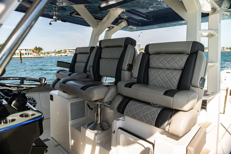 Slide: The Image of Luxurious seating on a 2021 Pursuit 428 boat with quilted upholstery, overlooking the water. - 8