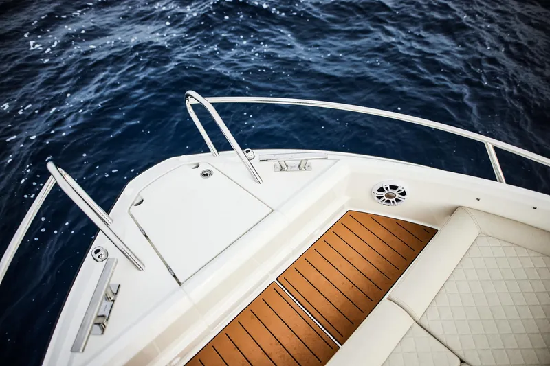 Slide: The Image of 2025 Skamander Sorrento boat deck with wood finish, overlooking deep blue ocean. - 11