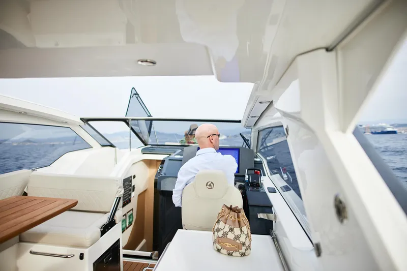 Slide: The Image of Man piloting 2025 Skamander Sorrento boat on open water. - 19