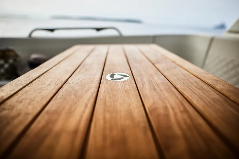 Slide: The Image of Wooden deck of Skamander Sorrento 2025 boat, featuring sleek design and logo. - 23